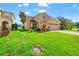 Charming 2-story home featuring a lush green lawn, a 2-car garage, and beautiful landscaping at 17509 Queensland St, Land O Lakes, FL 34638