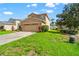 Traditional two-story home with a two-car garage, set on a well-maintained lawn at 17509 Queensland St, Land O Lakes, FL 34638