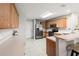 Well-lit kitchen with stainless steel appliances, ample counter space, and bar seating at 17509 Queensland St, Land O Lakes, FL 34638