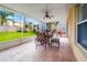 Relax on the covered lanai with tiled flooring, ceiling fan, and backyard views from the comfortable seating at 17509 Queensland St, Land O Lakes, FL 34638