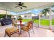 Enjoy the lanai with its screened-in patio, stylish furniture, and view of the manicured backyard at 17509 Queensland St, Land O Lakes, FL 34638
