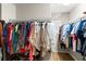 Spacious walk-in closet with ample storage, wooden floor, and organized hanging racks at 17509 Queensland St, Land O Lakes, FL 34638