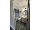 Well-lit bathroom featuring wood-look flooring, updated vanity, and a blue-striped shower curtain at 19743 Ellendale Dr, Land O Lakes, FL 34638