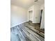 A cozy bedroom with modern gray wood-look flooring and a spacious closet for ample storage at 19743 Ellendale Dr, Land O Lakes, FL 34638
