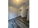 Bedroom with wood-look flooring, closet with shelving, neutral wall colors and natural lighting at 19743 Ellendale Dr, Land O Lakes, FL 34638