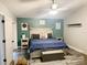 Cozy bedroom with a queen bed, stylish decor, and ample natural light at 19743 Ellendale Dr, Land O Lakes, FL 34638