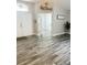 Bright foyer features stylish gray wood floors, neutral paint, and an inviting open layout at 19743 Ellendale Dr, Land O Lakes, FL 34638