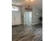 Open and airy foyer featuring double front doors and wood-look flooring at 19743 Ellendale Dr, Land O Lakes, FL 34638