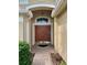 Inviting home entrance featuring a decorative transom window at 19743 Ellendale Dr, Land O Lakes, FL 34638