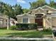 Charming single-Gathering home featuring a well-manicured lawn and lush landscaping at 19743 Ellendale Dr, Land O Lakes, FL 34638