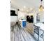 Modern kitchen with a blue island, stainless appliances, and open floor plan at 19743 Ellendale Dr, Land O Lakes, FL 34638