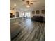 Bright open floor plan featuring hardwood floors, living room and kitchen area at 19743 Ellendale Dr, Land O Lakes, FL 34638