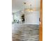 Spacious living room with modern gray wood floors, plants and open archways at 19743 Ellendale Dr, Land O Lakes, FL 34638