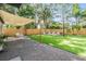 Lush backyard with artificial grass, lounge furniture, and a privacy fence for relaxing and entertaining at 201 W Alva St, Tampa, FL 33603