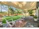 Spacious backyard featuring artificial grass, lounge chairs, and a shade canopy for outdoor enjoyment at 201 W Alva St, Tampa, FL 33603