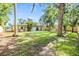 Large backyard with artificial turf and lounge chairs providing ample space for relaxation and outdoor activities at 201 W Alva St, Tampa, FL 33603