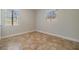 Neutral bedroom with tiled floor with natural light filtering in from the two windows at 201 W Alva St, Tampa, FL 33603