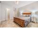 Bedroom showcasing a wooden bed frame and tiled floor, complemented by matching nightstands at 201 W Alva St, Tampa, FL 33603