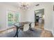 Bright dining area with modern light fixture, gray rug, and french doors to backyard at 201 W Alva St, Tampa, FL 33603