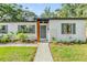 Inviting home exterior showcasing modern accents, beautiful landscaping, and a well-maintained walkway to the front door at 201 W Alva St, Tampa, FL 33603