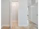 Hallway featuring neutral paint and tile floors, with an open closet at 201 W Alva St, Tampa, FL 33603