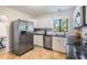 Modern kitchen with stainless steel appliances, granite countertops, and white cabinetry at 201 W Alva St, Tampa, FL 33603