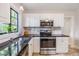 Bright kitchen featuring updated stainless steel appliances and ample counter space at 201 W Alva St, Tampa, FL 33603