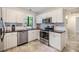 Well-equipped kitchen with modern appliances, white cabinets, and tile floors at 201 W Alva St, Tampa, FL 33603