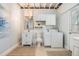 Laundry room featuring front load washer and dryer, storage cabinets, and sink with a mirror at 201 W Alva St, Tampa, FL 33603