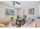 Inviting living room featuring tile floors, a large window, and comfortable seating arrangement at 201 W Alva St, Tampa, FL 33603