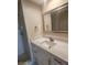 Bathroom vanity featuring white cabinetry, granite countertop, and shower at 209 Corkwood Ln Ln, Oldsmar, FL 34677