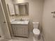 Bathroom vanity featuring marble countertop and decorative framed mirror at 209 Corkwood Ln Ln, Oldsmar, FL 34677