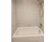 Tiled shower and tub combination with neutral colored tile surround at 209 Corkwood Ln Ln, Oldsmar, FL 34677