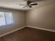 Comfortable bedroom with wood-look flooring, ceiling fan, and a bright window at 209 Corkwood Ln Ln, Oldsmar, FL 34677