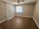 Bedroom with sliding doors, wood-look flooring, ceiling fan, and a bright window at 209 Corkwood Ln Ln, Oldsmar, FL 34677