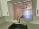 Updated kitchen featuring stainless steel sink and new countertops overlooks the living room at 209 Corkwood Ln Ln, Oldsmar, FL 34677