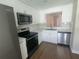 Bright kitchen features stainless steel appliances, granite countertops, and crisp white cabinetry at 209 Corkwood Ln Ln, Oldsmar, FL 34677