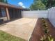 A brick patio provides a nice outdoor space next to a white vinyl fence and tidy landscaping at 209 Corkwood Ln Ln, Oldsmar, FL 34677
