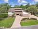 Aerial of luxury home with beautiful landscaping, circular driveway, and mature trees at 2103 N Golfview Dr, Plant City, FL 33566