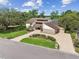 Expansive property with beautiful landscaping, large driveway, and unique architectural design at 2103 N Golfview Dr, Plant City, FL 33566