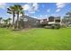 Beautiful backyard featuring an enclosed pool area and lush landscaping, ideal for outdoor enjoyment at 2103 N Golfview Dr, Plant City, FL 33566