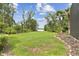 Lush backyard featuring a well-manicured lawn and stunning water views at 2103 N Golfview Dr, Plant City, FL 33566