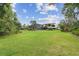 Lush green backyard with ample space, showcasing the property's outdoor living potential at 2103 N Golfview Dr, Plant City, FL 33566