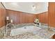 Large bathtub with granite surround in bathroom, featuring dual faucets and floral accents at 2103 N Golfview Dr, Plant City, FL 33566