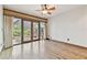 Bright bedroom with wood floors and glass doors that leads to an enclosed porch area, ideal for relaxing at 2103 N Golfview Dr, Plant City, FL 33566