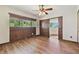 Bedroom featuring wood flooring, paneling, and windows providing ample natural light and views at 2103 N Golfview Dr, Plant City, FL 33566