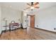 Bright, hardwood-floored bedroom showcasing an open layout and plenty of natural light from multiple light sources at 2103 N Golfview Dr, Plant City, FL 33566
