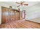Large bedroom with ceiling fan, wood floors, and built-in wood cabinets and drawers at 2103 N Golfview Dr, Plant City, FL 33566