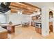Eat-in kitchen with a built-in booth and dining table, wooden beams, and stainless steel appliances at 2103 N Golfview Dr, Plant City, FL 33566