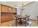 Elegant dining room with hardwood floors, a chandelier, and built-in wooden cabinets at 2103 N Golfview Dr, Plant City, FL 33566